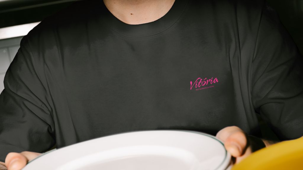 Aplicação da identidade visual do Vitória Hotel e Restaurante em camiseta personalizada utilizada pela equipe.